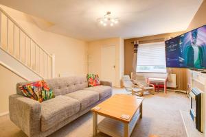a living room with a couch and a tv at Comfortable 3 bed house in Chelmsford in Chelmsford