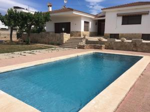 a swimming pool in front of a house at Casa Bel in Sant Carles de la Ràpita