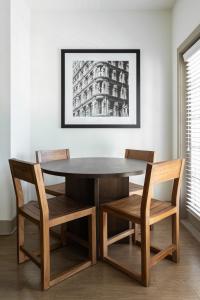 a dining room table and chairs with a picture on the wall at Kasa Southside Wilmington in Wilmington