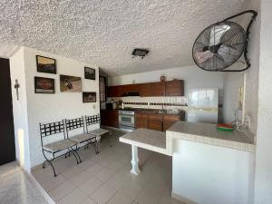 a kitchen with a table and chairs in a room at Depa Roca Sola Acapulco Costera in Acapulco