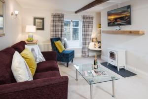 a living room with a couch and a fireplace at Castle Retreat - luxury apartment opposite Alnwick Castle in Alnwick
