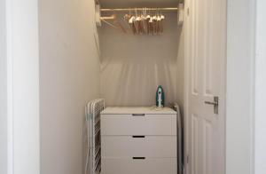 a closet with a sink and a dresser in a room at Traditional Studio Apartment in Fitzrovia near Oxford Street in London
