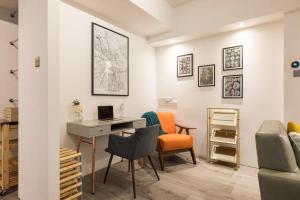 a living room with a desk and a chair at Central Soho Warehouse Loft with Concierge in London
