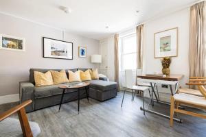 a living room with a couch and a table at Modern 3-bed Duplex Apartment in Fitzrovia near Oxford Street in London