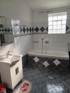 a bathroom with a sink and a bath tub at Babis House in Limenaria +67 photos