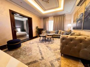a living room with a couch and a table at Khozama AlNahda in Jeddah
