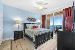 a bedroom with a bed and a view of the ocean at Phoenix Gulf Shores Unit 1702 in Gulf Shores