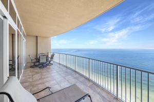 a balcony with chairs and a view of the ocean at Phoenix Gulf Shores Unit 1702 in Gulf Shores