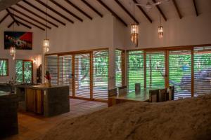a large room with wooden blinds on the windows at Finca Carpe Diem Ecolodge in Minca