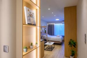 a hotel room with a bed and a room with a door at CityZen_io in Ioannina