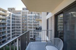a balcony with two chairs and a view of a building at Amazing studio front the Barton Park at Clarendon in Arlington