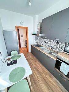 a kitchen with a table and some chairs in it at Soleo guesthouse in Monza