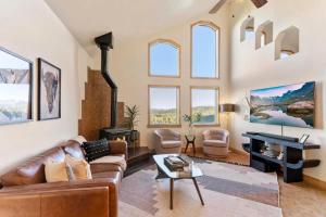 a living room with a couch and a fireplace at St Mary's Glacier Retreat w Hot Tub & Views in Idaho Springs
