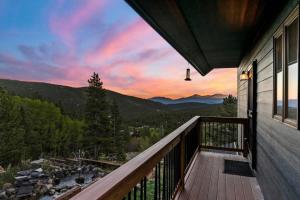 a balcony of a house with a view of the mountains at St Mary's Glacier Retreat w Hot Tub & Views in Idaho Springs