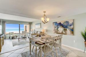 a dining room and living room with a table and chairs at B162 Surf & Racquet - 1BR at Amelia Surf & Racquet Club next to The Ritz! in Amelia Island