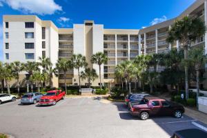 a parking lot in front of a large building at B162 Surf & Racquet - 1BR at Amelia Surf & Racquet Club next to The Ritz! in Amelia Island