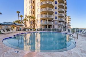 a swimming pool in front of a apartment building at 58 Ocean Place - Luxury 2BR 2Ba oceanfront condo right next door to the Ritz Carlton in Fernandina Beach