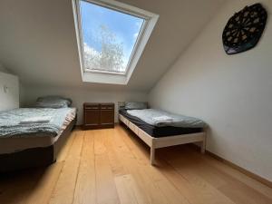 two twin beds in a room with a window at Monteurzimmer In Durlach! By Simplex in Karlsruhe