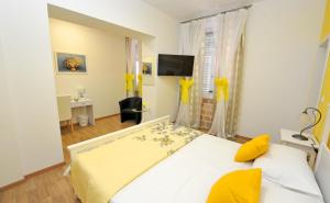 a bedroom with a bed with yellow pillows at Luxury Rooms Nirvana in Split