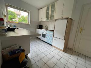 a kitchen with white cabinets and a white refrigerator at Monteurzimmer In Durlach! By Simplex in Karlsruhe