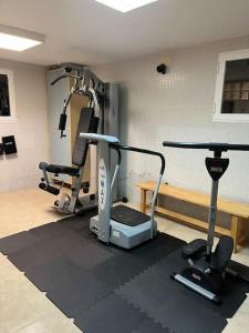 a gym with two exercise bikes and a treadmill at Casa Galiana. in Argés