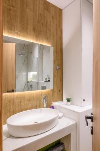 a bathroom with a white sink and a mirror at CityZen_io in Ioannina