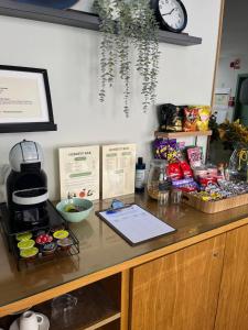 a counter with a coffee maker and food on it at Sintra Green Chalet Bed & Breakfast in Sintra