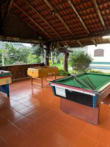 a pool table sitting on a tiled patio at Pousada Melodia in Nova Friburgo