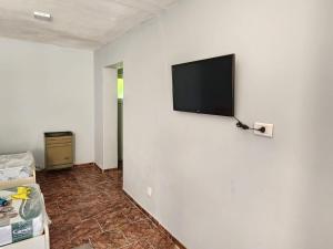 a room with a flat screen tv on a wall at DEPARTAMENTO CENTRO in Zapala