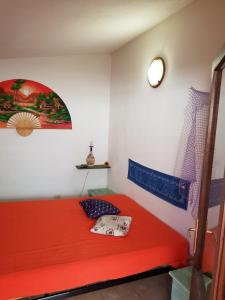 a bedroom with a red bed in a room at Villa Stella in Costa Paradiso