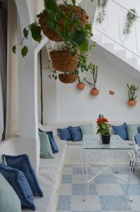 a room with a table and potted plants at Selva María Hotel Boutique in Santa Fe de Antioquia