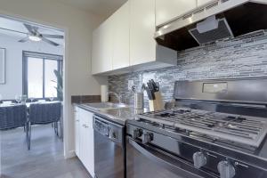 a kitchen with a stainless steel stove and a counter top at Perfect Executive Studio at Clarendon in Arlington