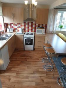 a kitchen with a stove and a counter top at Coastal Annex at Saltfleet in Louth