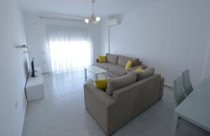 a living room with a couch and a table at Aparthotel Miramare in Sarandë