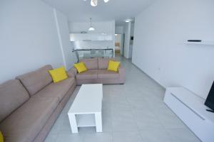 a living room with a couch and a table at Aparthotel Miramare in Sarandë