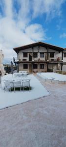 a building with tables and chairs in the snow at Vegas de la Alcarria in Horche