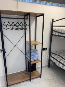 a room with bunk beds and a shelf with towels at Castillo Principal in Almansa
