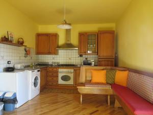 a kitchen with a couch in the middle of a kitchen at La Superba Ca' Zeneize in Foiano della Chiana