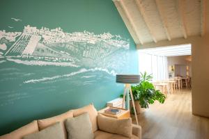 a living room with a mural on the wall at Praia FLH Hotels Ericeira in Ericeira
