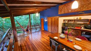 a dining room with a wooden table in a house at Pincoya- Private Tropical House near Playa Chiquita Beach in Punta Uva