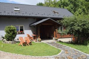 a group of chairs sitting outside of a house at MATOGÓWKA in Krzeszowice