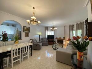 a living room with a couch and a table at Encantadora VILLA con piscina en Playa Flamenca in Alicante