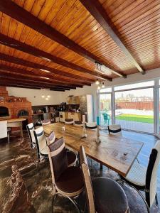 a dining room with a large wooden table and chairs at Casa Dutu in Tuzla