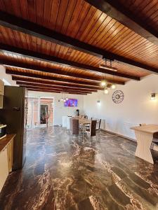 a large room with a table and a dining room at Casa Dutu in Tuzla
