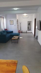 a living room with a blue couch and a table at MRȘ House 2 in Bucharest