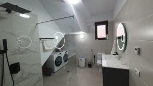 a white bathroom with a sink and a toilet at MRȘ House 2 in Bucharest