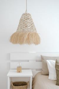 a pendant light hanging over a bed with a table at Casa da Sereia in Leiria