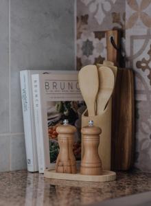 a book and some wooden chess pieces on a counter at Casa da Sereia in Leiria