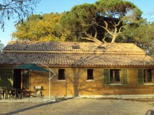 a wooden house with a table and chairs in front of it at HERMITAGE in Anzex