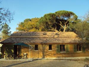 a wooden house with a table and chairs in front of it at HERMITAGE in Anzex